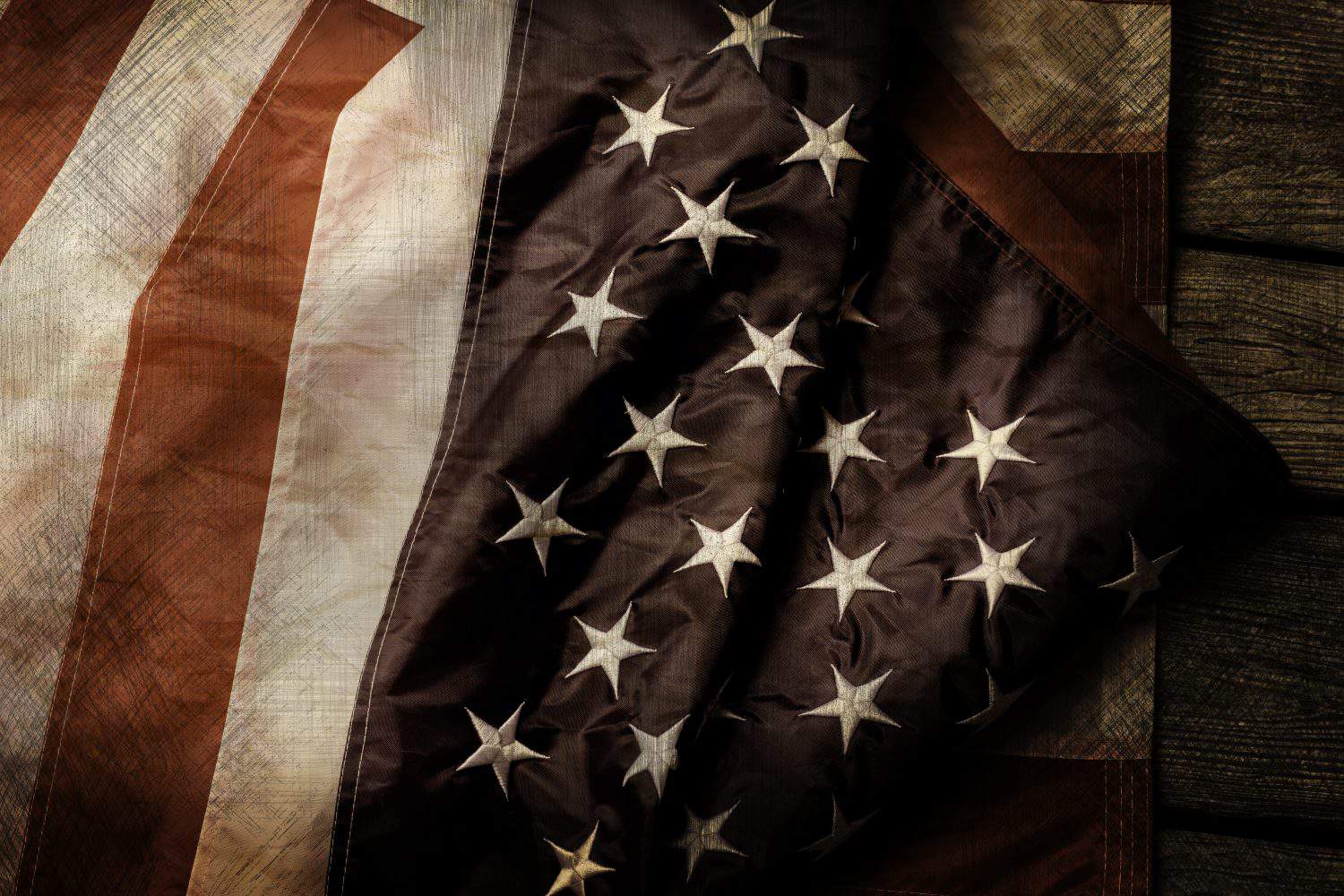 Aged and crumpled US flag. Old flag on wooden background. Courage, honor and loyalty. Fallen shall be forever remembered.