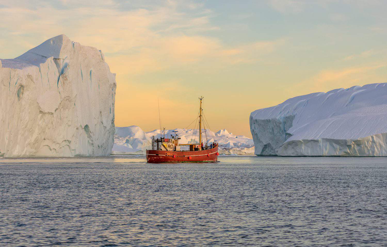 Tourists take pictures of the iceberg. Source of icebergs is by the Jakobshavn glacier. This is a consequence of the phenomenon of global warming and catastrophic thawing of ice, Disko Bay, Greenland.