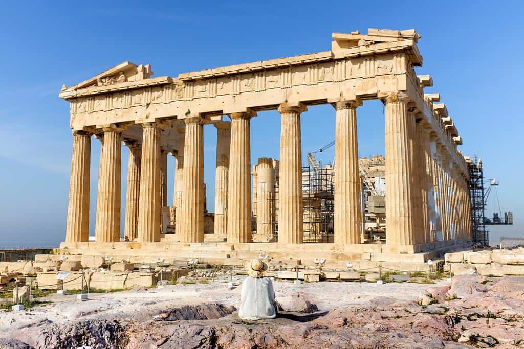 Lady sitting in front of Parthenon on Acropolis, Athens, Greece by Kristoffer Trolle