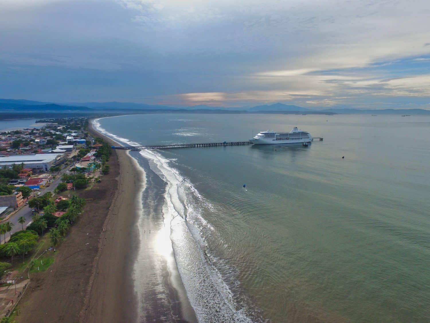 Puntarenas, Costa Rica with a cruise in the main dock at the end of the beach