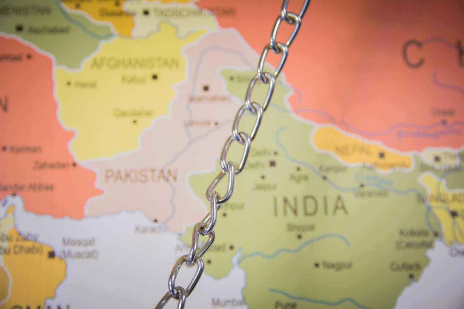 top shot of India and Pakistan border on Map with a chain India Pakistan conflict