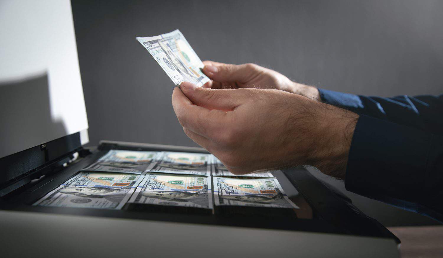 Man copying a money on a copy machine.