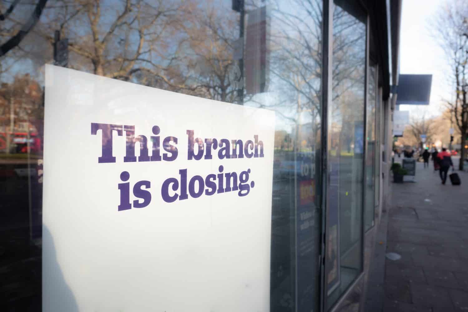 Sign in high street shop window &#039; This Branch is Closing&#039;. Representative of a retail trend.