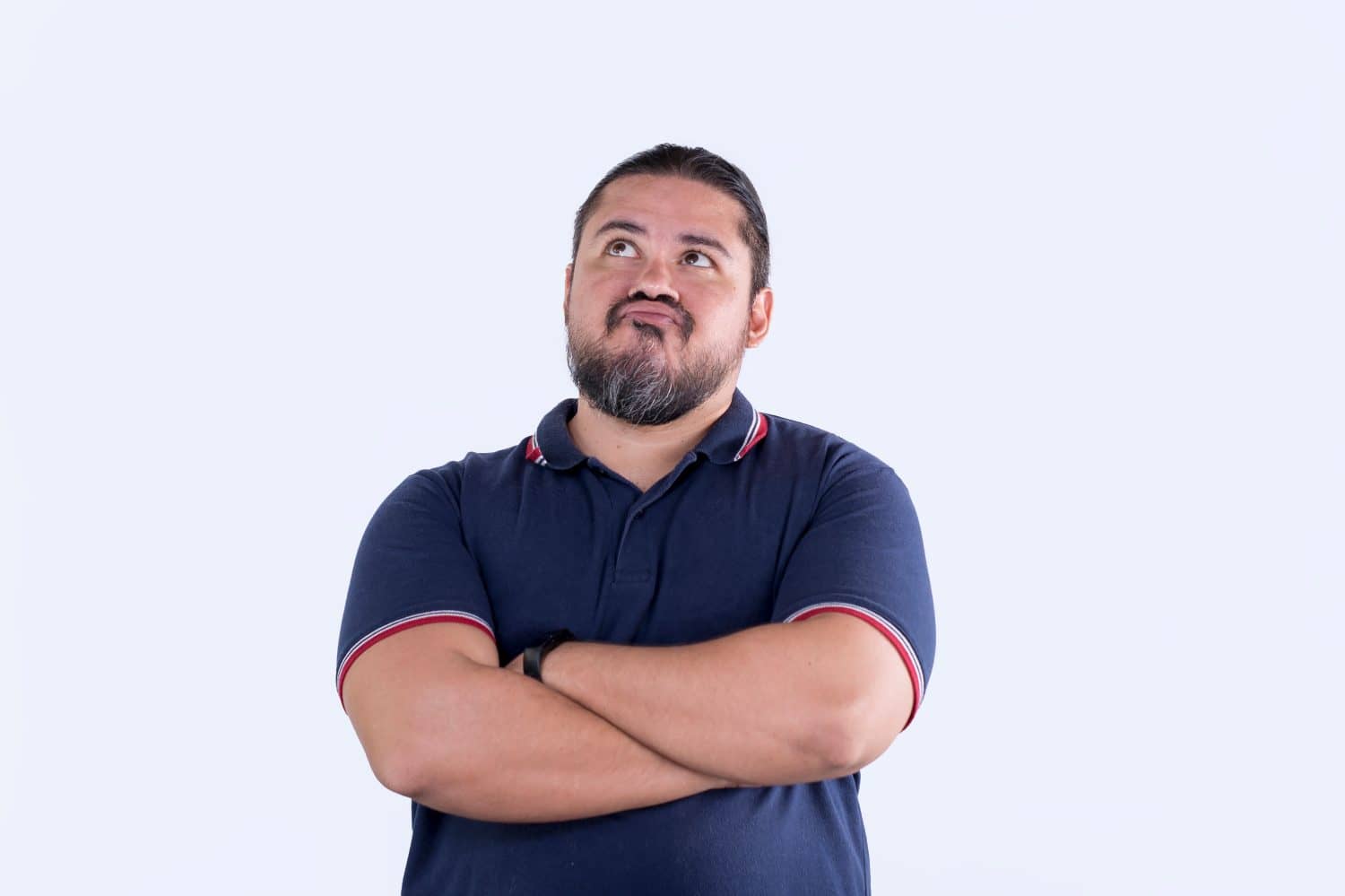 A man inadvertently makes a funny face while pondering his options. Isolated on a white background.