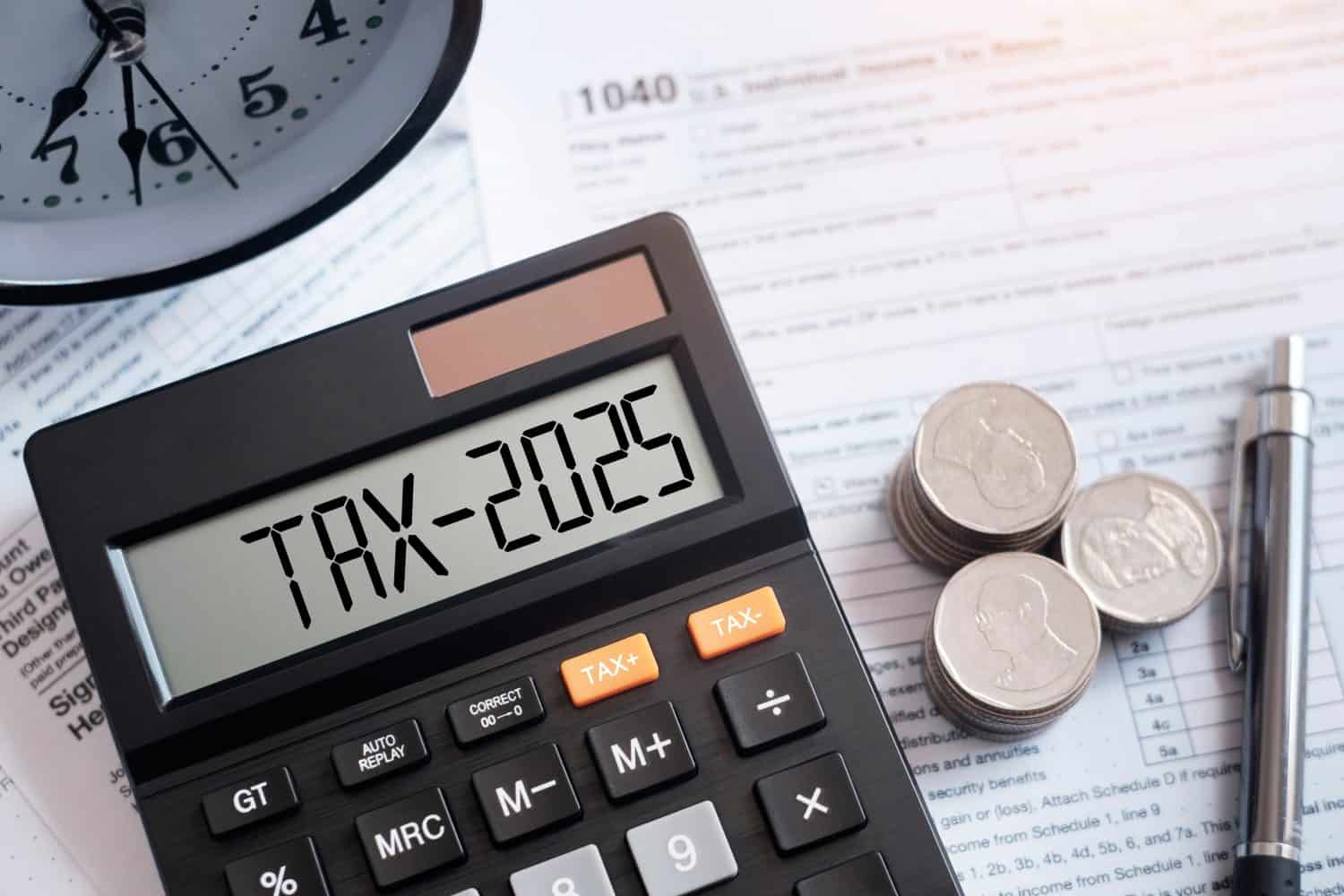 Word Tax 2025 on the calculator on documents.Income Statement. paying the tax rate. Taxation, taxes burden.Business and tax concept.