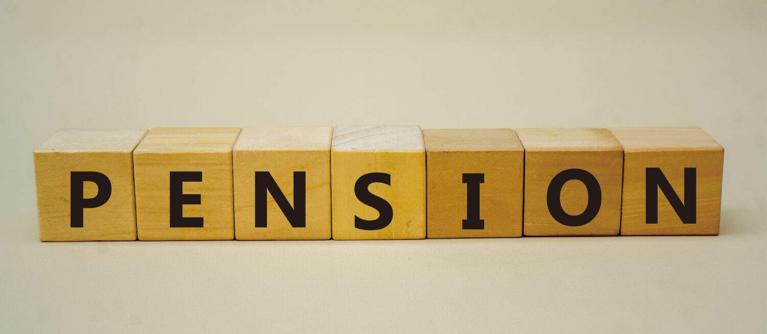 PENSION symbol. Copy space. Concept word PENSION on wooden blocks with yellow background. Business and financial concept.