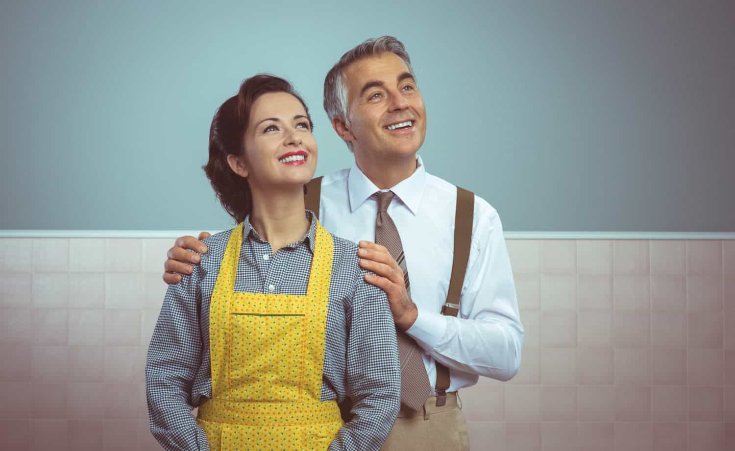 Happy vintage couple at home posing and smiling at camera