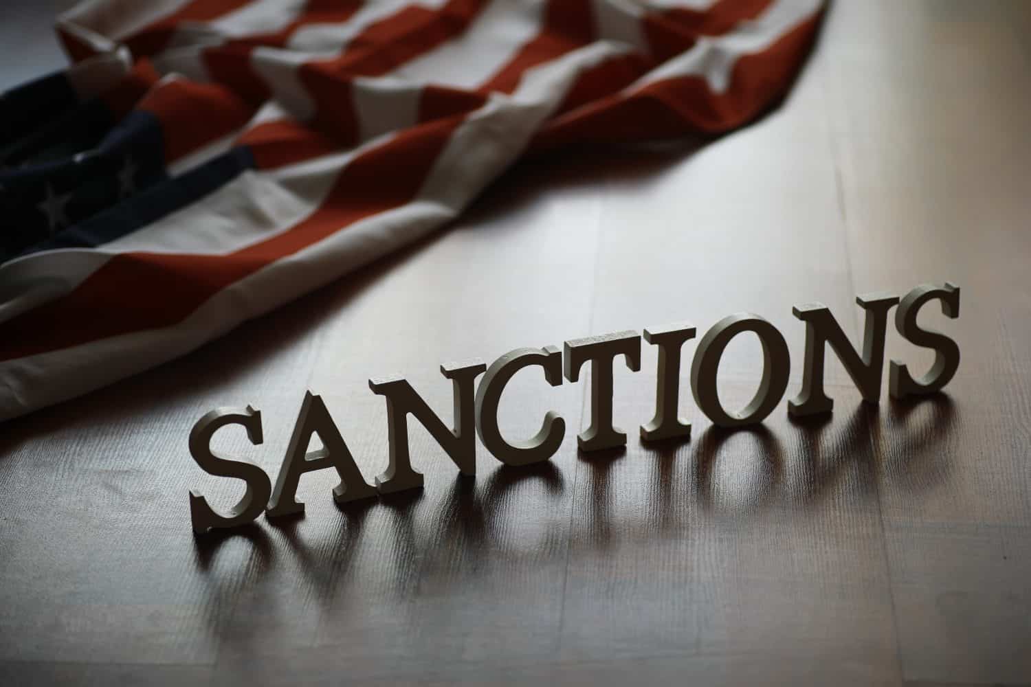 Economic Sanctions Concept with American Flag Background