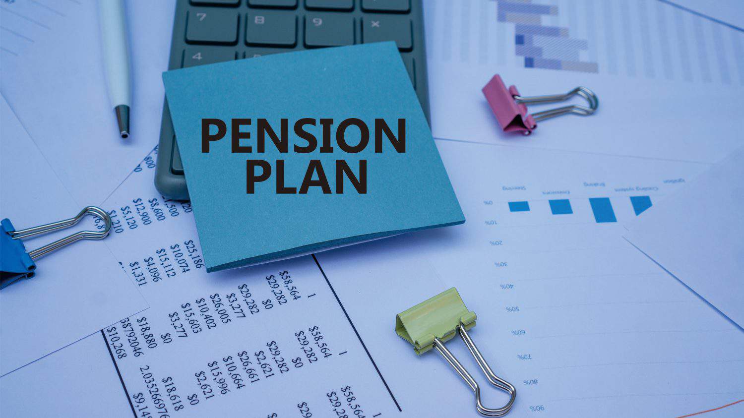 PENSION PLAN word. Copy space. Concept word PENSION PLAN on wooden blocks with diagram chart on the background. Business and financial concept.