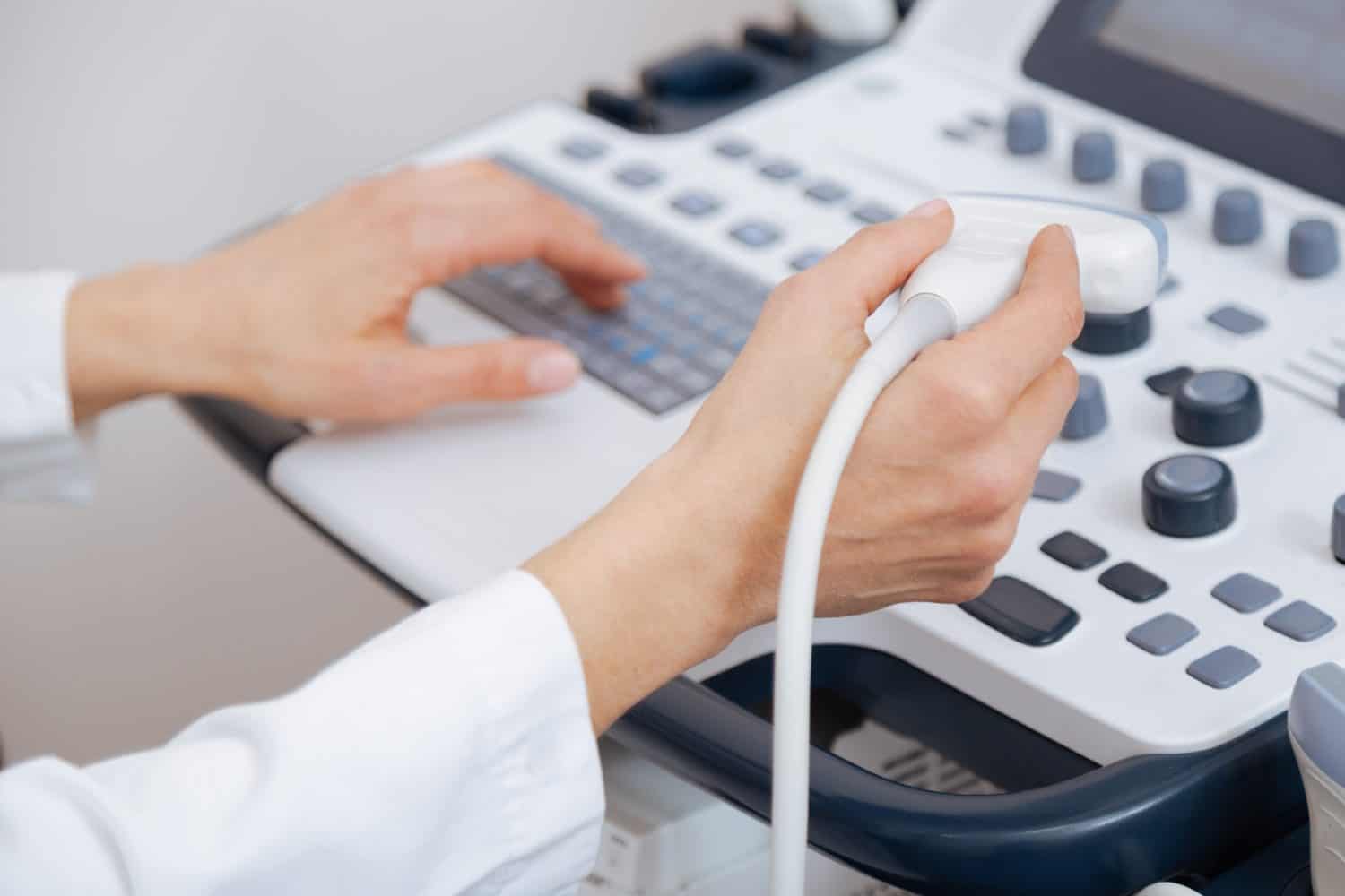 Skillful sonographer using ultrasound machine at work