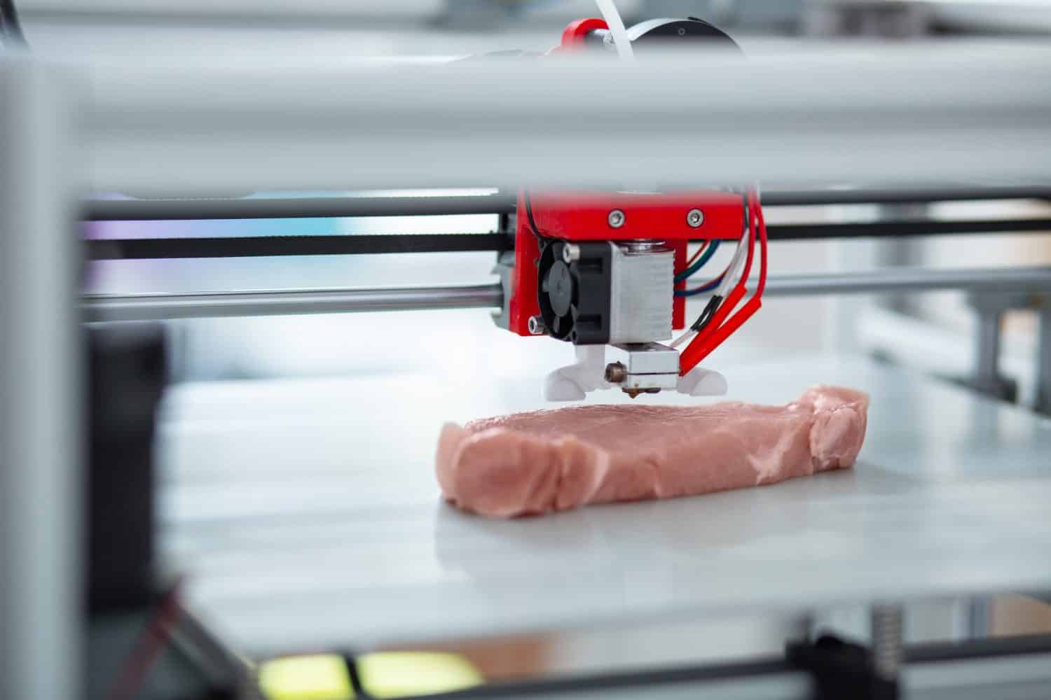 Absolutely alike. The close up of a 3D printer recreating a piece of meat, imitating all the little details