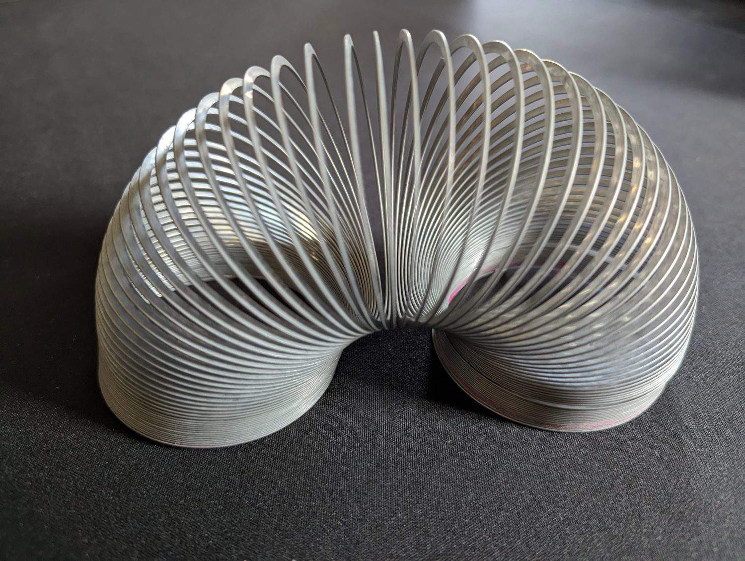 A closeup view of a metallic helical coil toy popularly known as a &quot;Slinky&quot;.