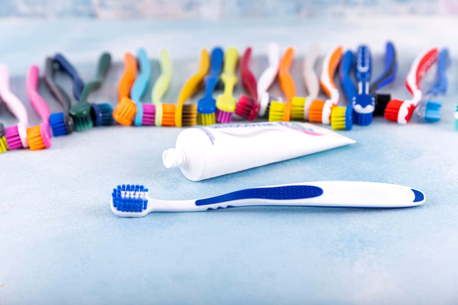 Toothbrush and dental floss. Set of colorful toothbrushes with toothbrush, dental floss on a blue background.