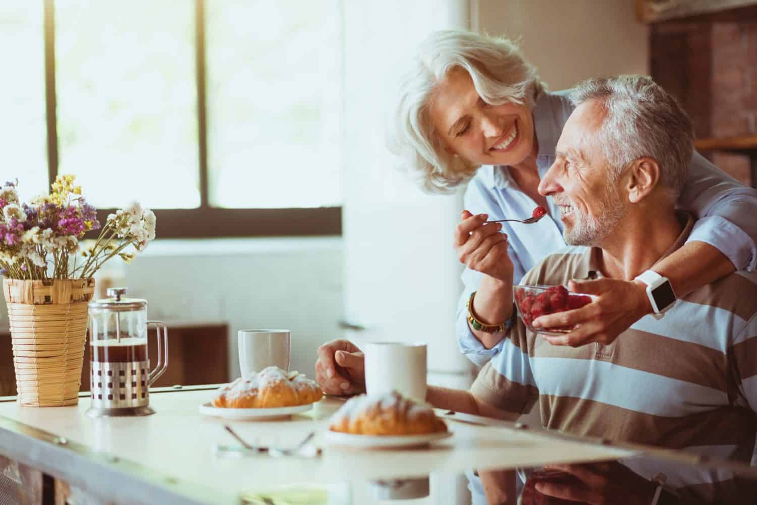 Positive loving aged coupel having breakfast