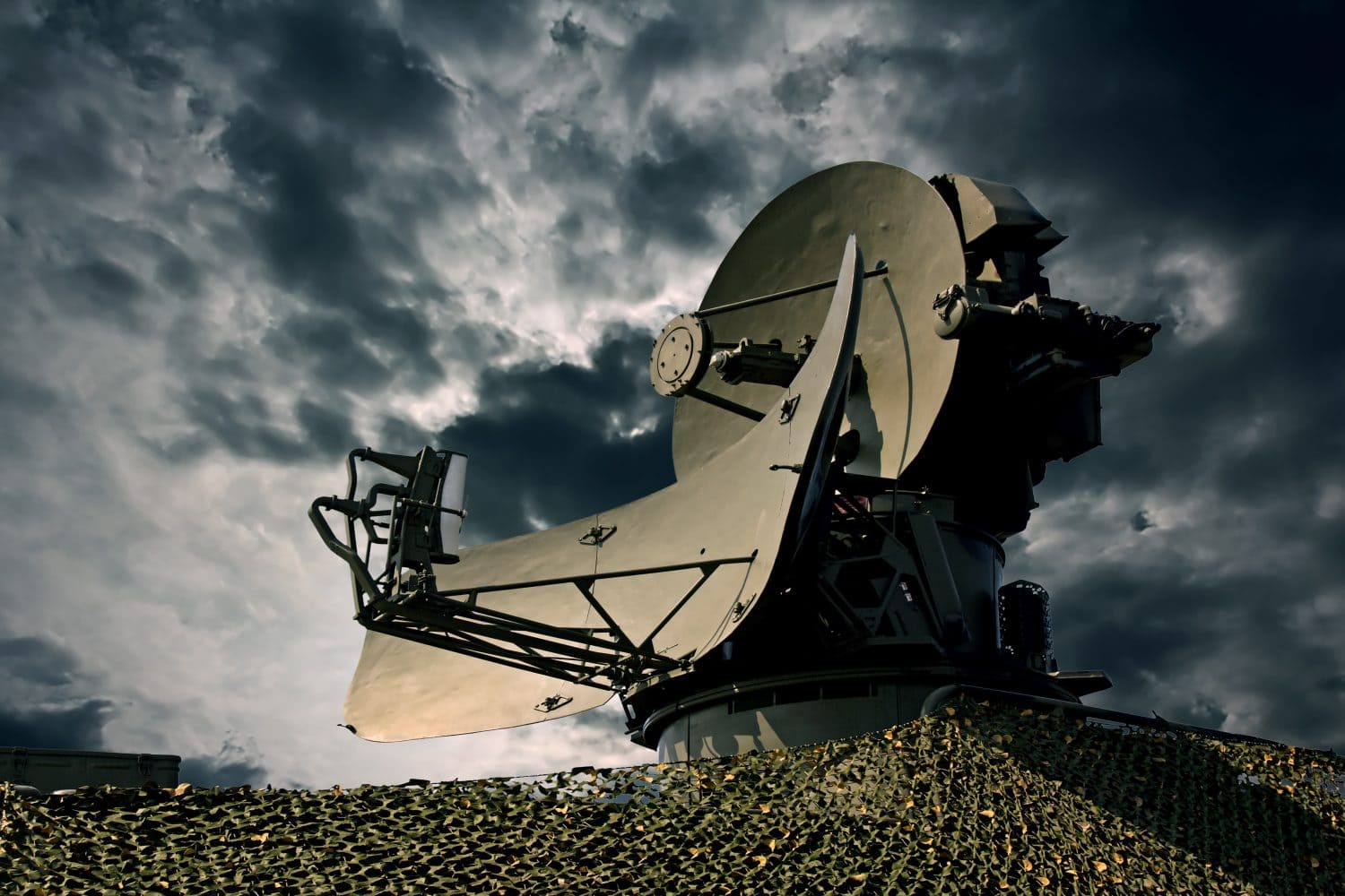 Air defence radar over dramatic night sky.