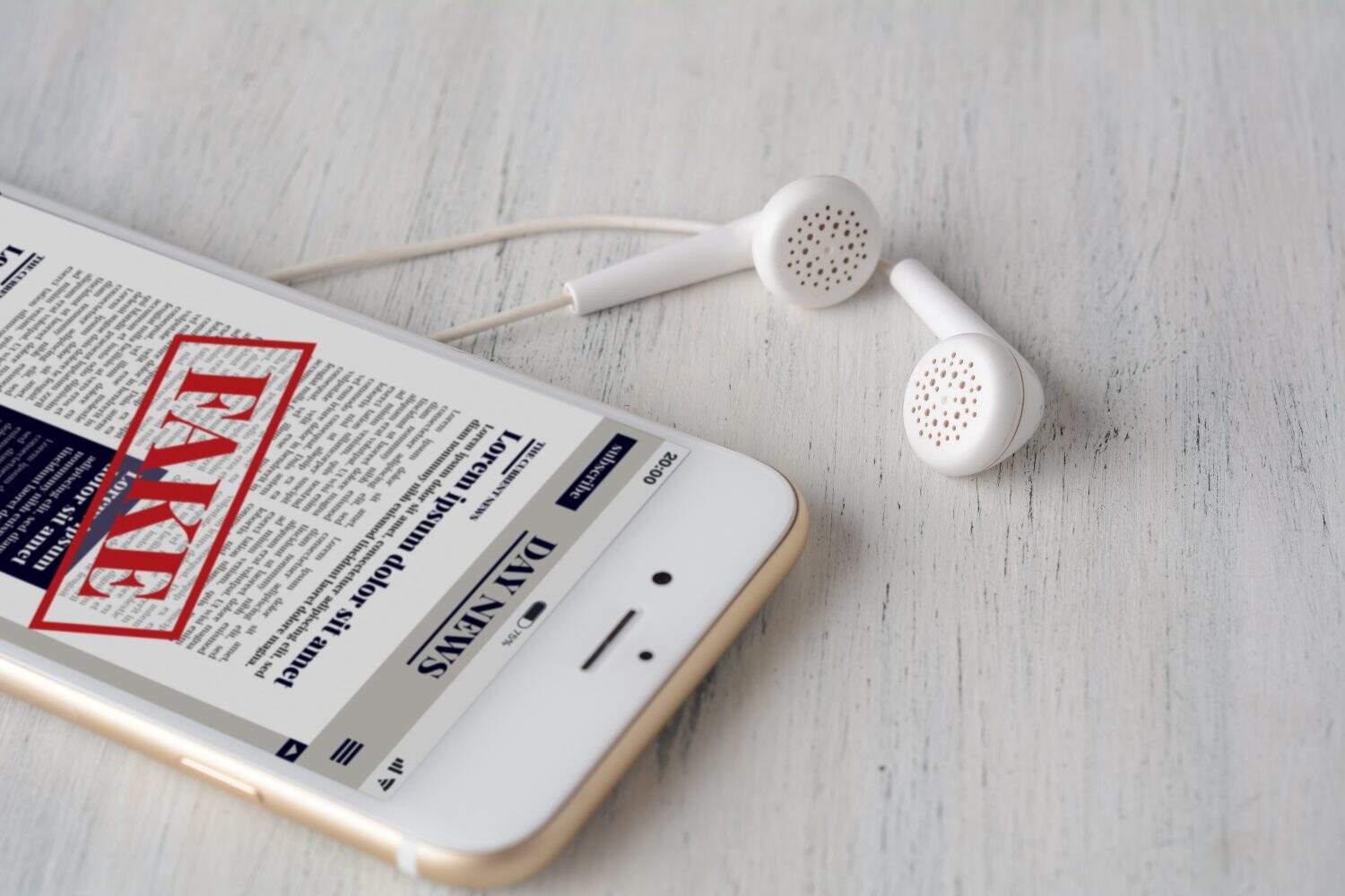 Close up view of earphones and fake News on smartphone. Propaganda and disinformation online. Media and digital concept. All screen graphics are made up by us