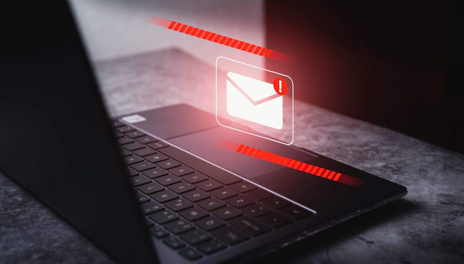 Email spam virus concept. Internet security and cybercrime. Phishing email, fraud, scam and virus warning on laptop.