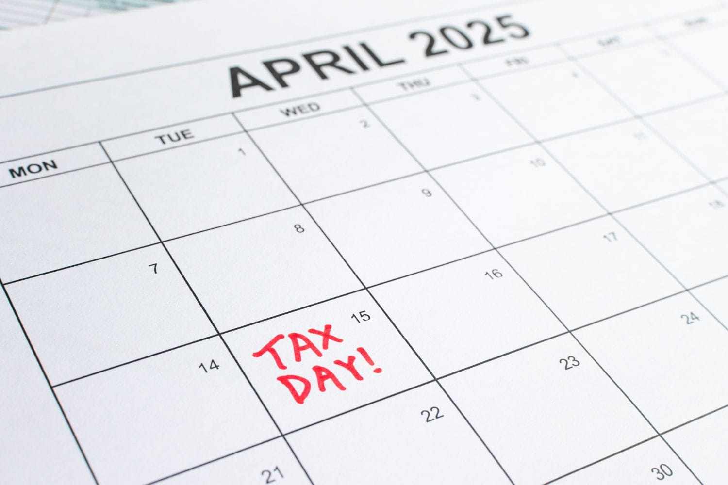 Calendar of April 2025, with “Tax Day!” reminder on the 15th. Deadline for filing Individual Income Tax Return and Corporate Tax Return. Taxation, tax season, tax reminder, regulatory filing concept