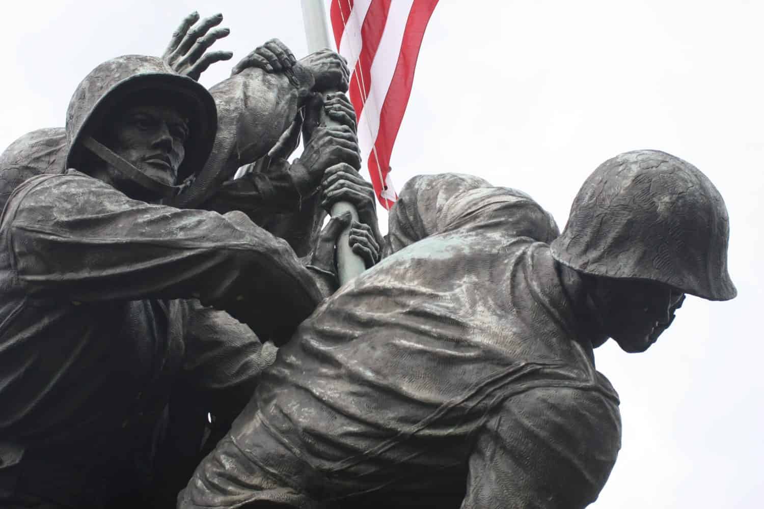 The United States Marine Corps War Memorial in a close-up of the Marines raising the American Flag. Stark, with the flag lending color to the scene.