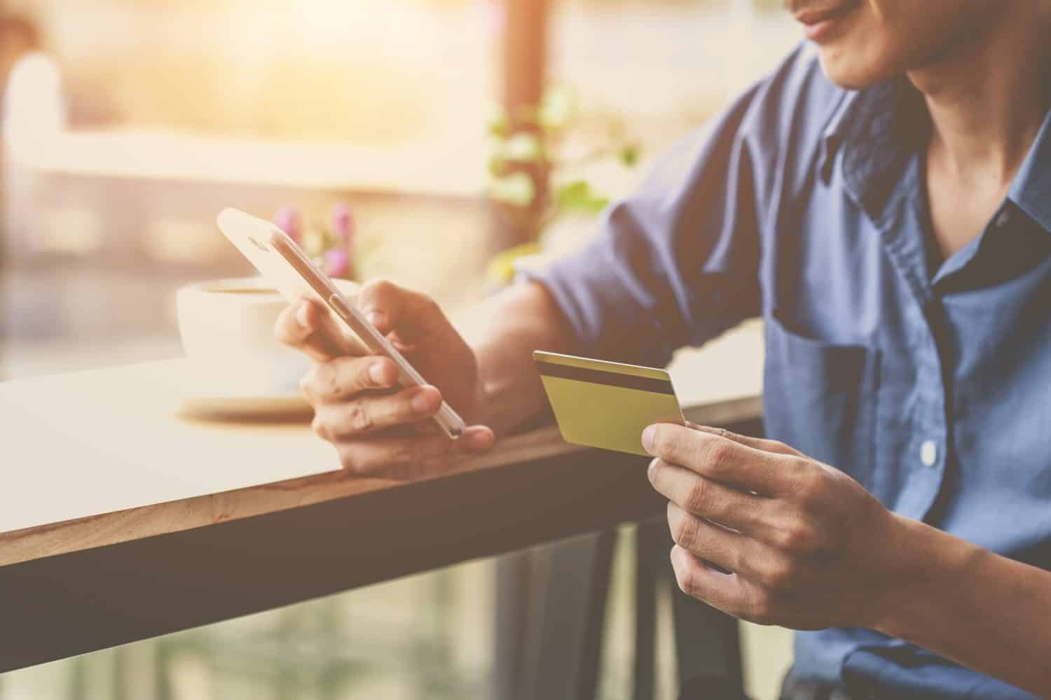 Man using mobile smartphone and credit card. Shopping Online