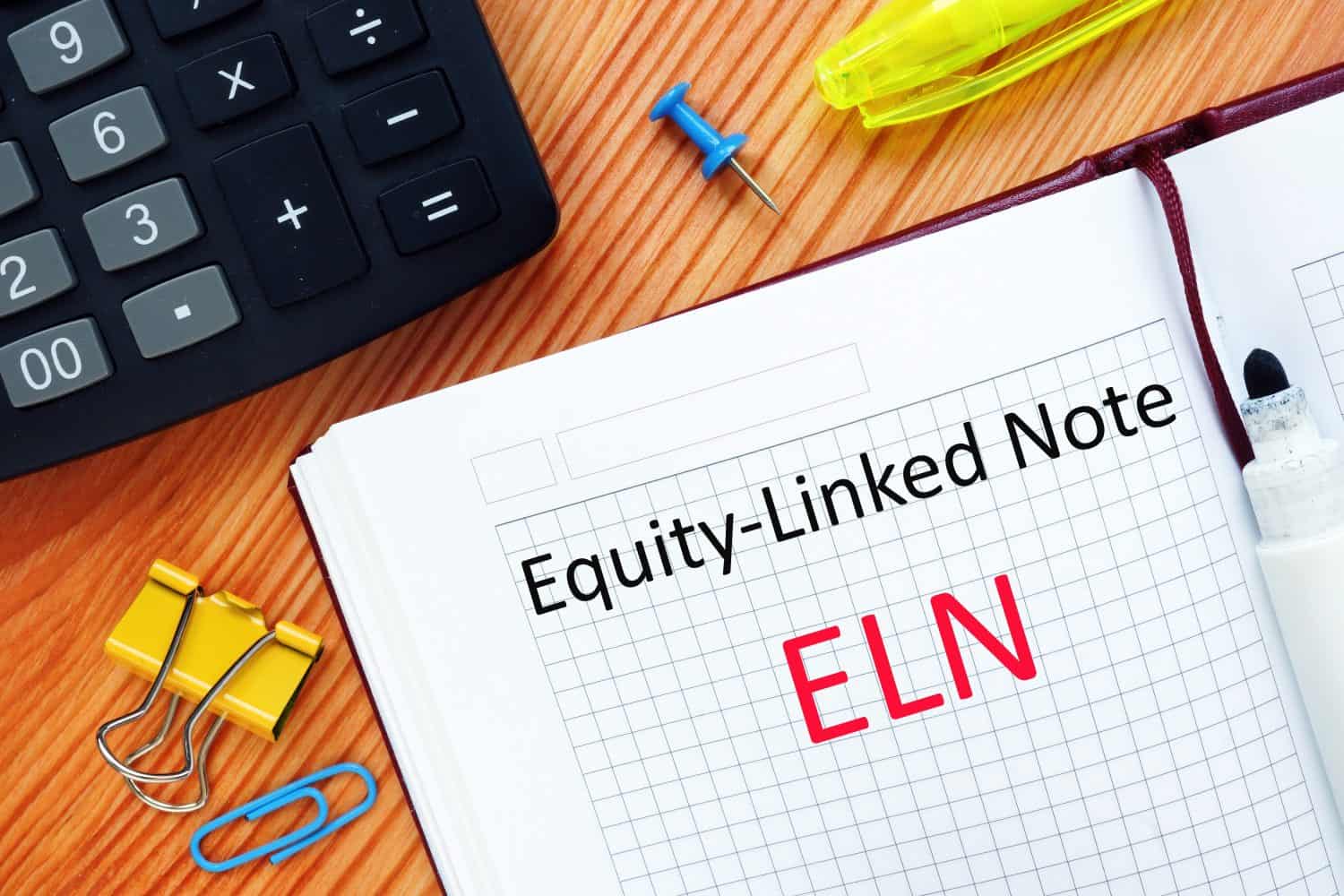 The caption in the picture is Equity-Linked Note ELN. Notebook sheet, table, pens.