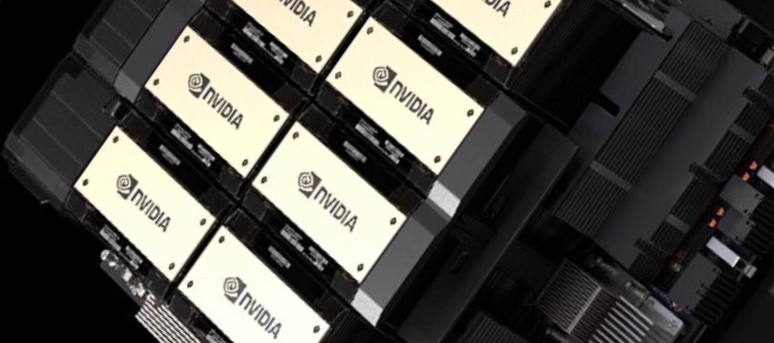 An overhead, slightly angled view of several beige-colored rectangular Nvidia processor modules arranged in a grid-like pattern. Each module features the black Nvidia logo and a stylized 'N' swirl. Dark, intricate hardware components, possibly heatsinks and circuit boards, surround and connect the modules against a black background, highlighting the dense, high-tech nature of the system.