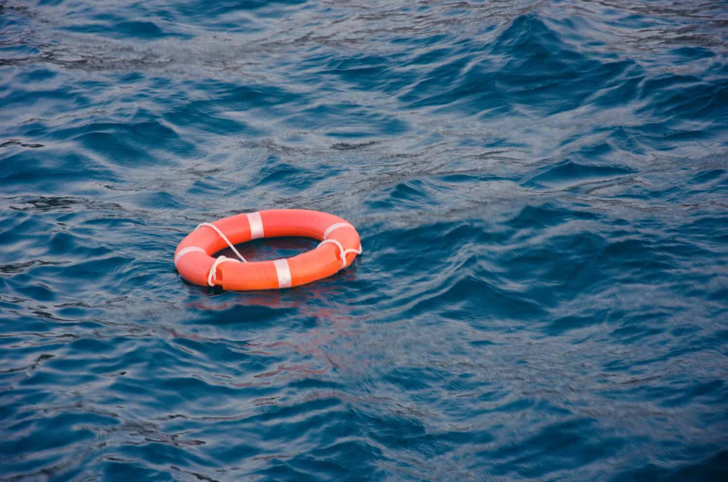 Orange life buoy loop in the sea