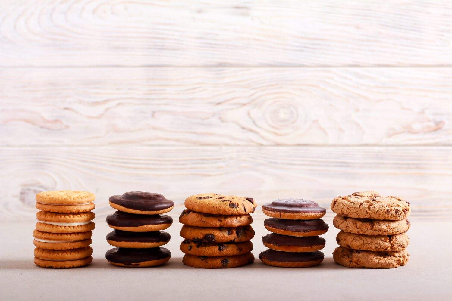 Selection of girl scout cookies over white wooden background
