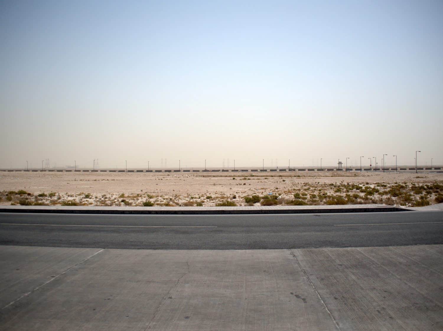 Light poles and power lines in the desert at Al Udeid