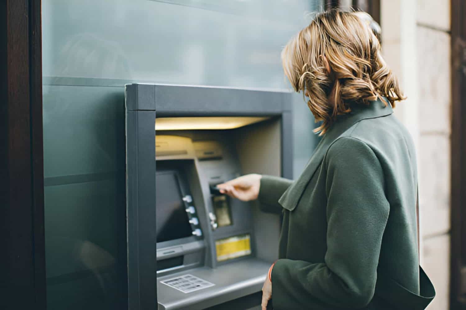 Women on ATM machine withdrawing cash
