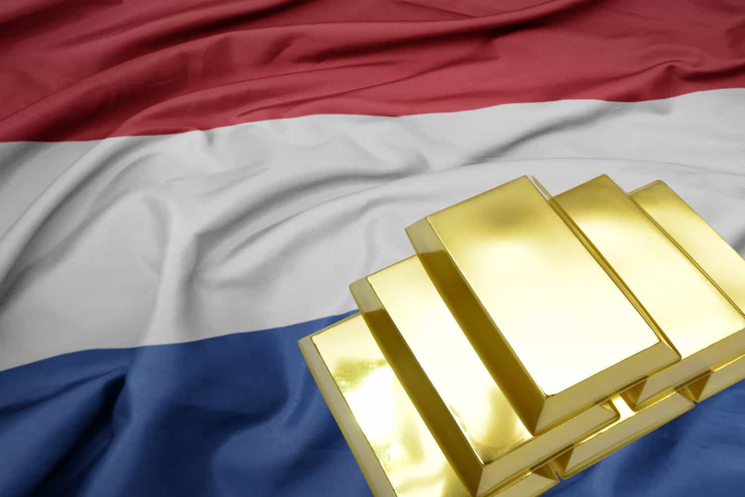 shining golden bullions on the netherlands flag background. gold reserves.