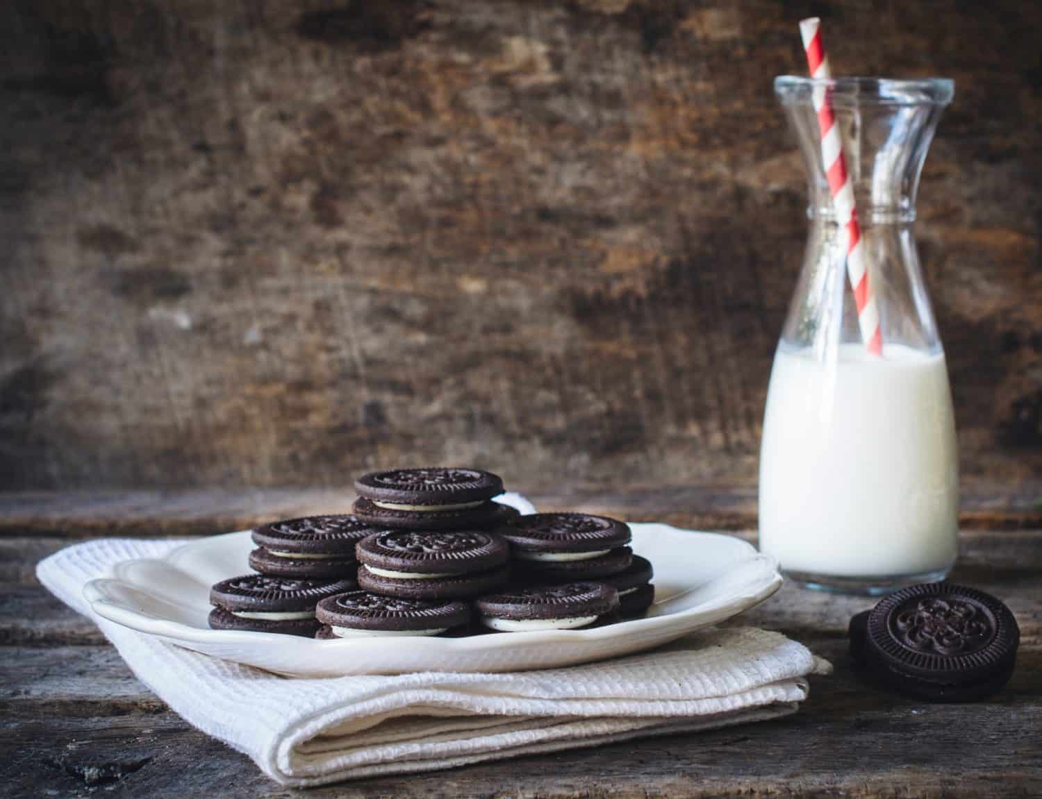 Sweet chocolate cookies and bottle of milk on wooden background,selective focus and blank space