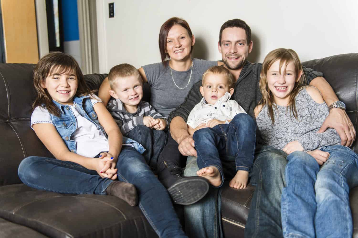 A Portrait of family having fun in the living room. Happy family spending time at home together.
