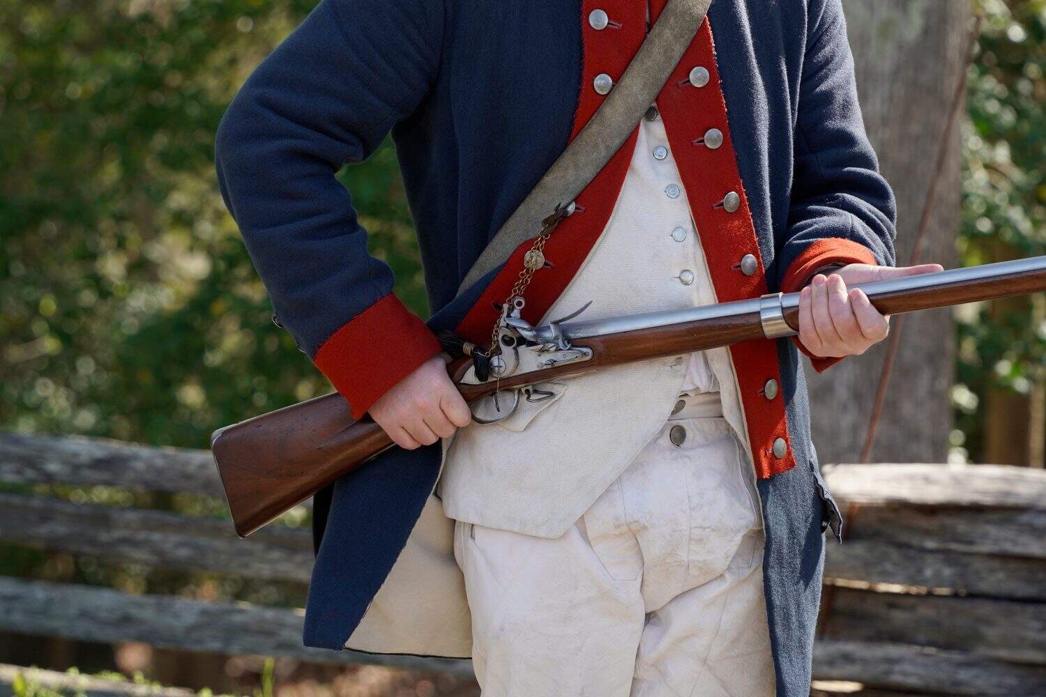 musket on hands of American Revolution british soldier settler in Yorktown, Virginia USA