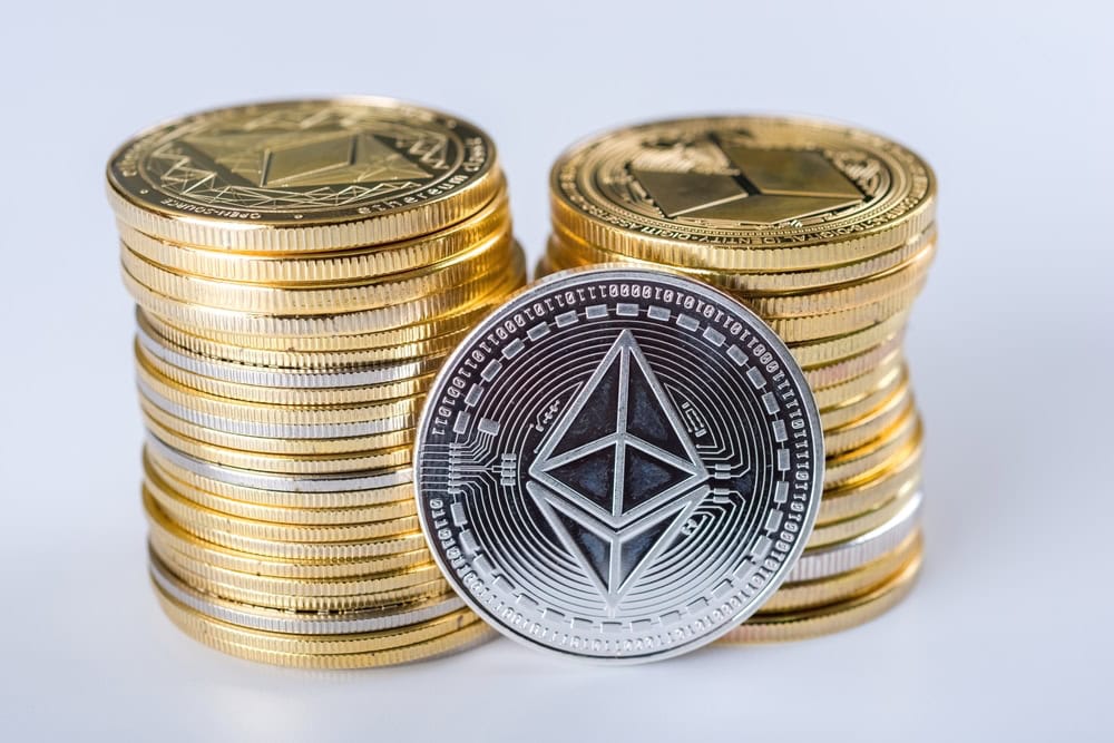 Cryptocurrency concept. Shining Ethereum Classic cryptocurrency coin in front of two piles gold coins . selective focus.
