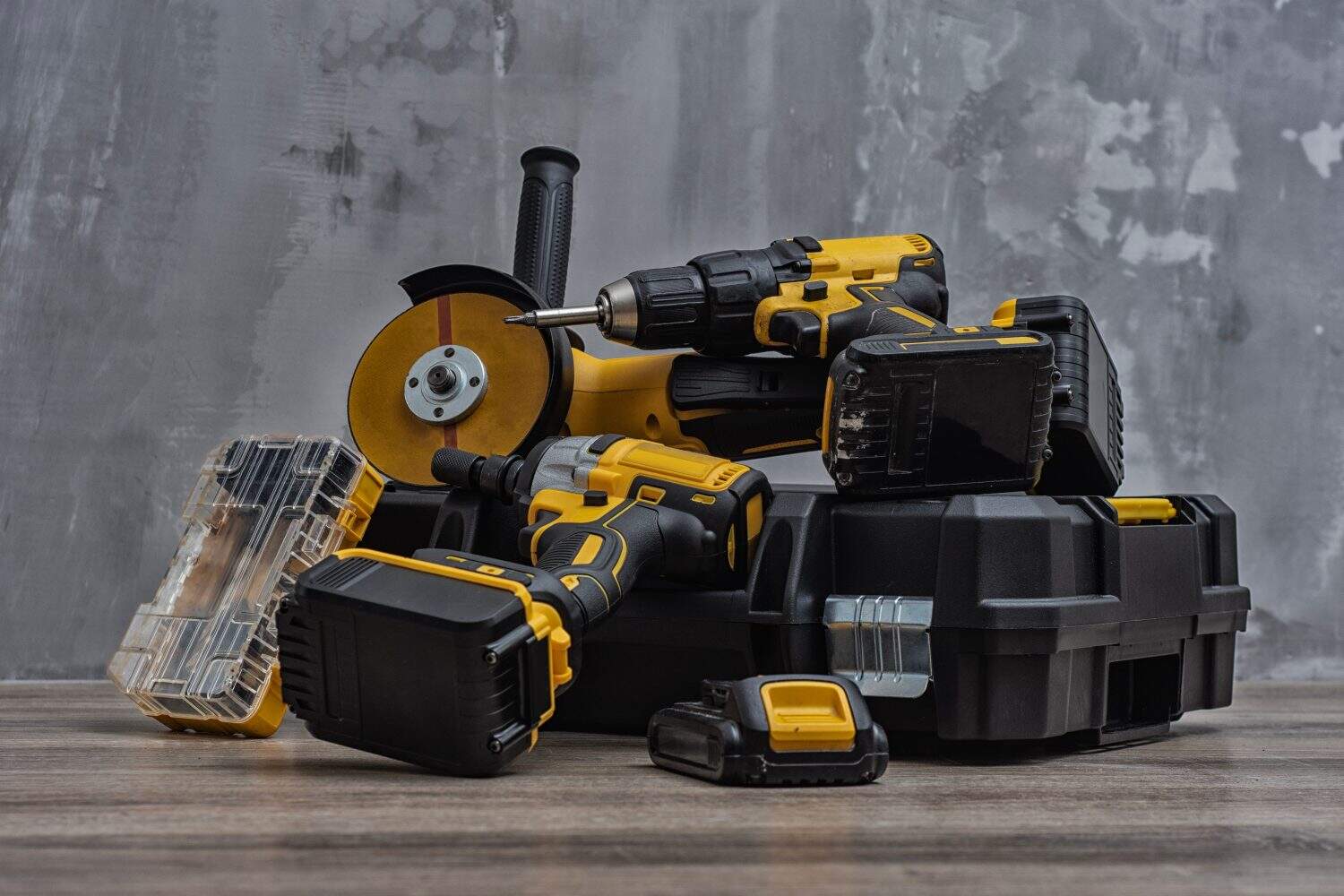 Professional cordless tool set. Angle grinder, screwdriver and impact wrench with batteries and tool box. Concept for construction, repair, renovation and DIY projects