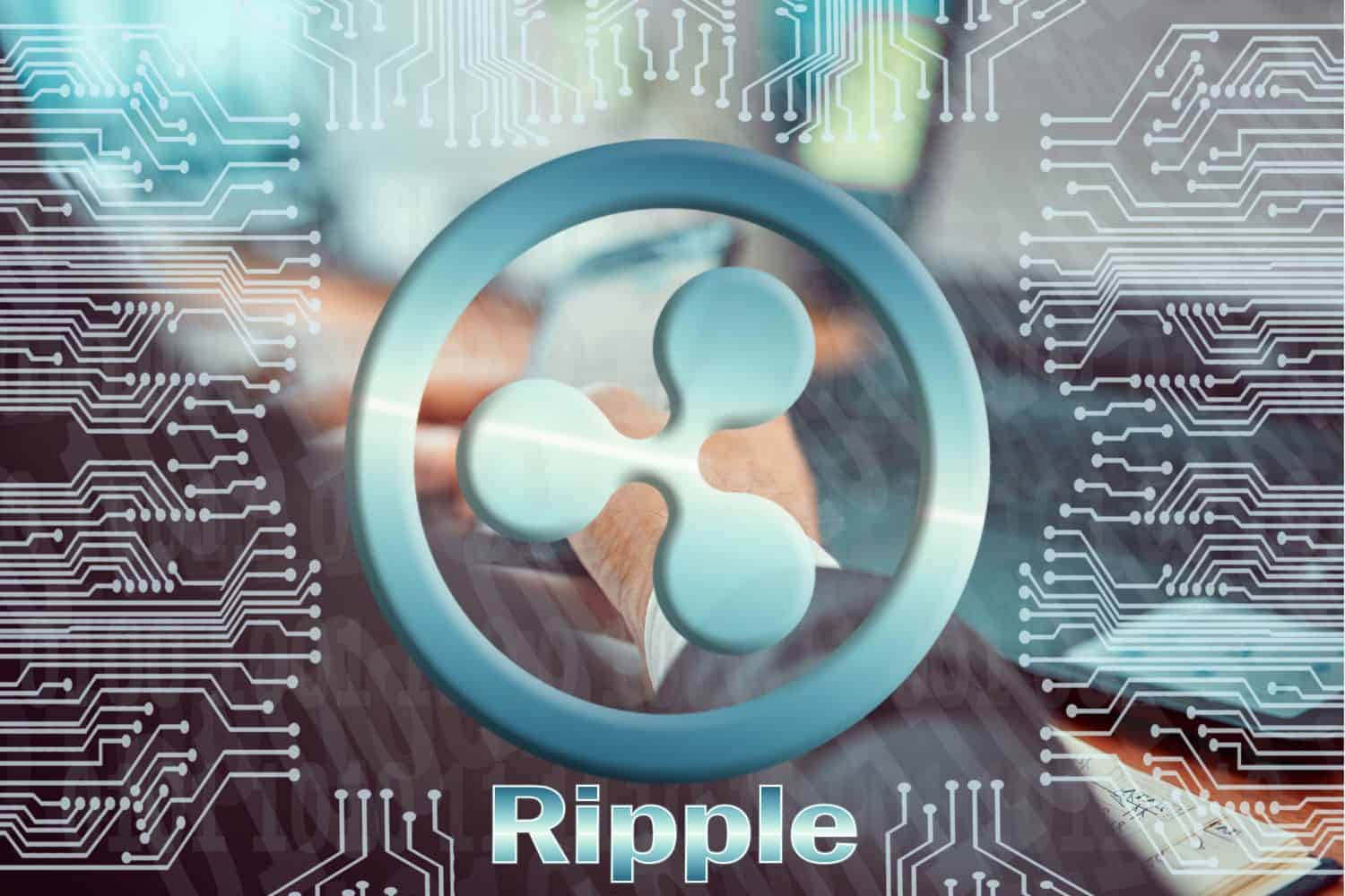 Circuit board on background of man working at laptop and holding smartphone in his hands. ripple XRP cryptocurrency symbol. Digital currency concept, blockchain, cryptocurrency mining.