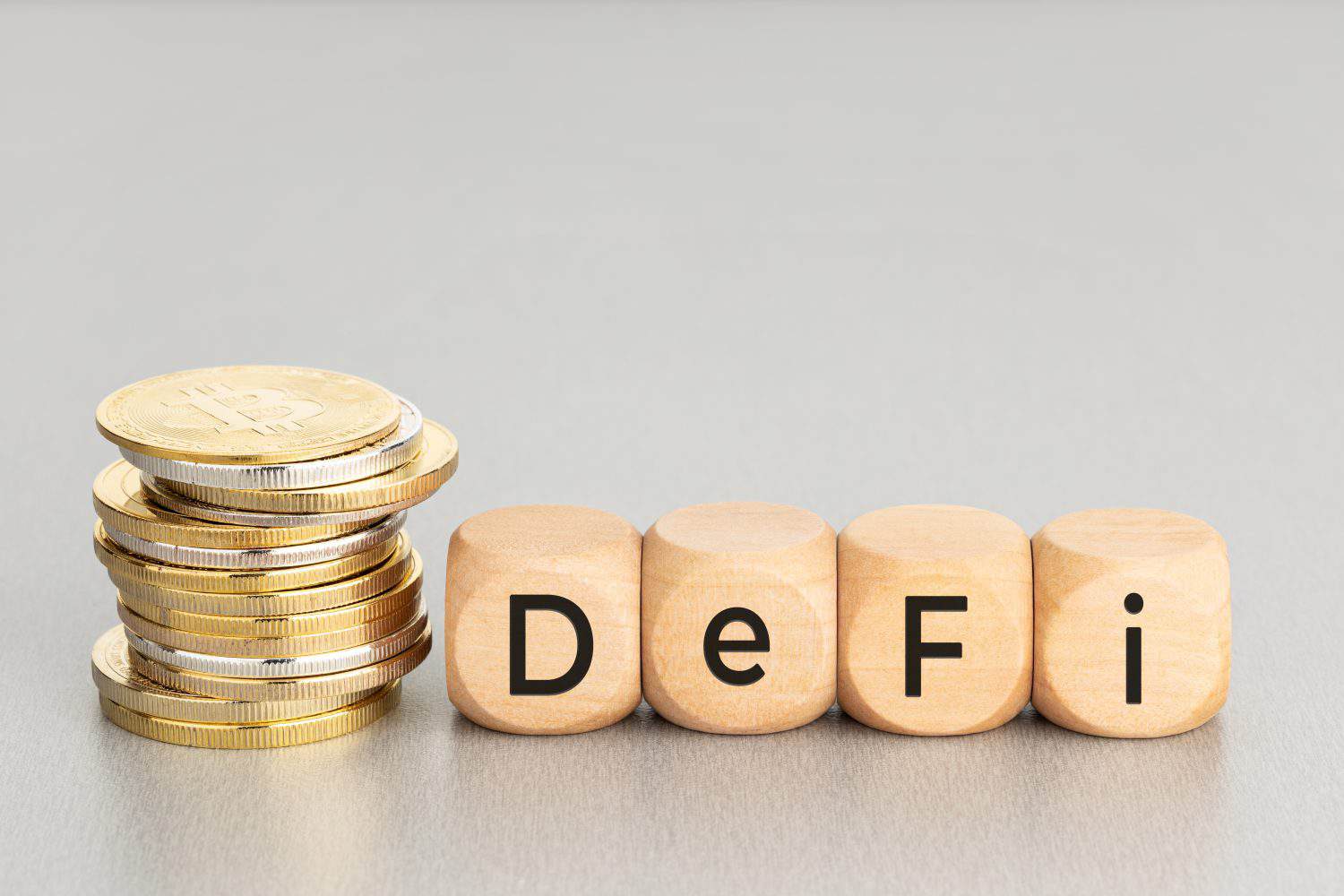 DEFI Cryptocurrency concept. Stacked crypto coins and wooden blocks with text. Copy space