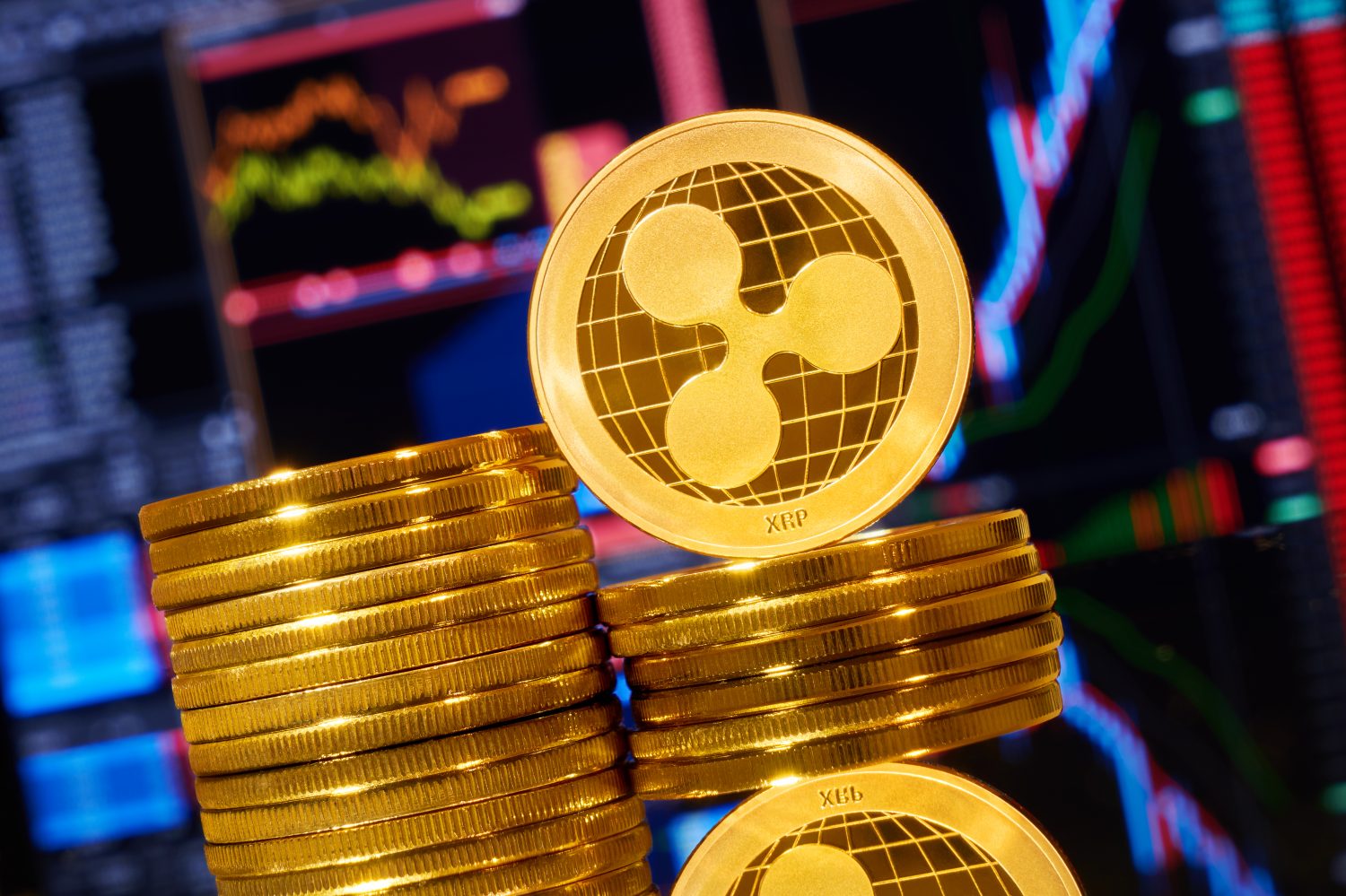Gold ripple stacked on a bright background of business graphics close-up. Ripple crypto-currency. Anonymous. Virtual currency